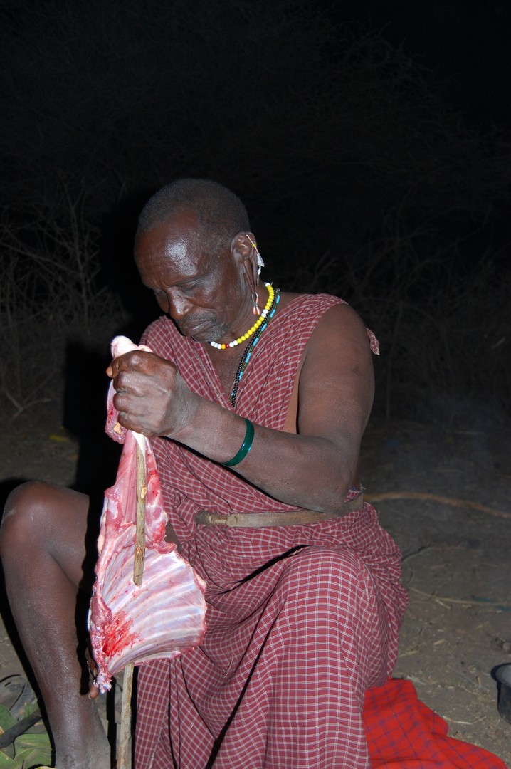 Maasai preparing Nyama Choma (barbecue meat), Engaruka Village