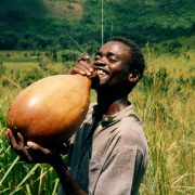 A man from Congo drinks water from a traditional calabash