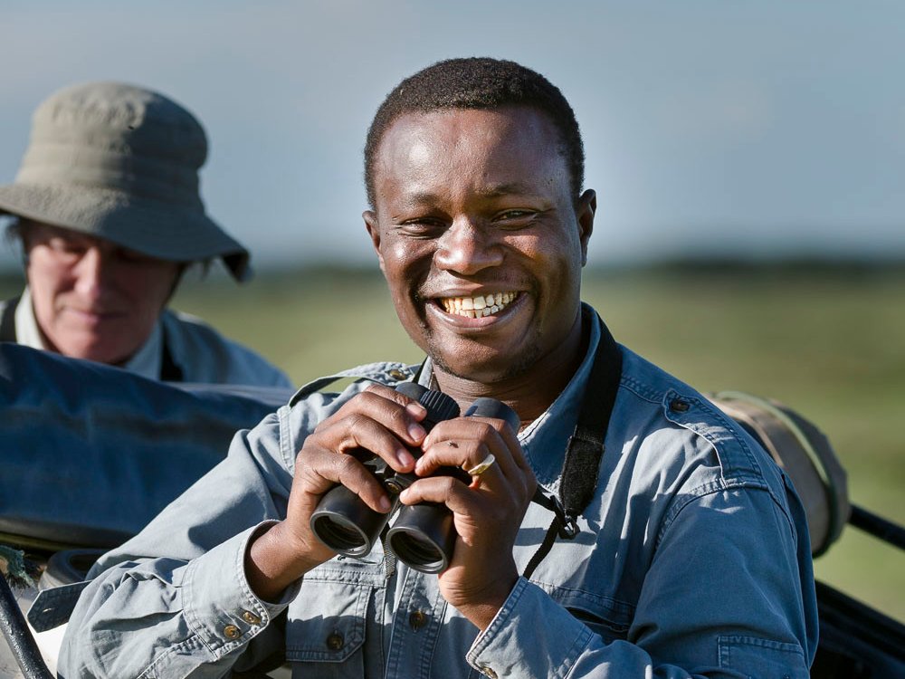 Tanzania Experts Guide Jombi with binoculars