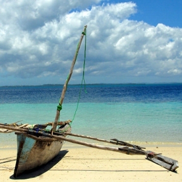 Traditional fishing boat on the fine beach of Zanzibar